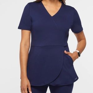 Jaanuu scrubs. Navy tulip scrub top with two pockets. Size XXS.